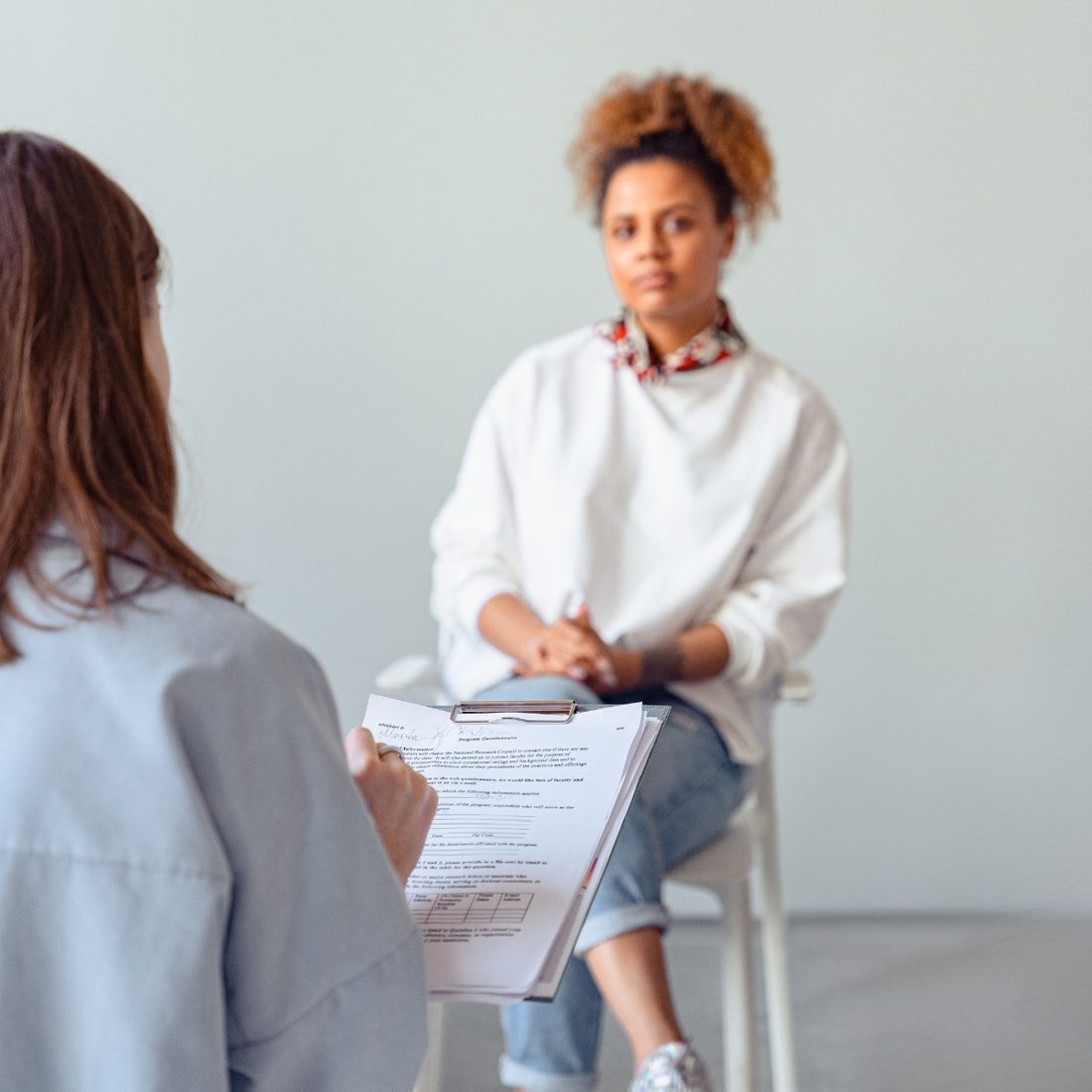 A coach taking notes during a session with a client