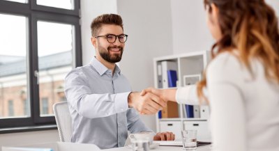 A candidate shaking hands across a desk